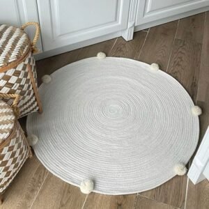 cotton rope rug, round area rug, pom-pom rug, handmade rug, boho nursery rug, kids playroom rug, soft cotton rug, eco-friendly rug, aesthetic home decor, modern minimalist rug